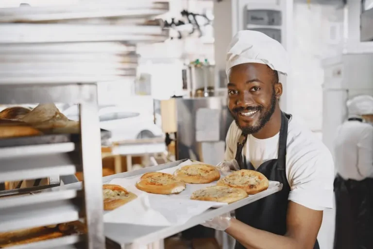 An african baker in a bakery with baking equipment